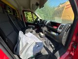 a red van with a bag in the back of it