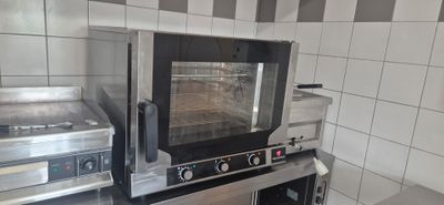 a small oven that is sitting on a counter in a kitchen