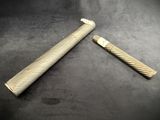 pair of antique brass - plated razors on a black background