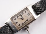 a watch that is sitting on a white surface