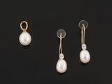 three pairs of pearl and diamond earrings on a black surface