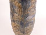 a vase that is sitting on a white surface