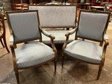 two chairs and a table in a room with a lot of furniture