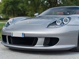 a silver sports car parked on the side of the road