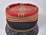 a red and black hat sitting on top of a table