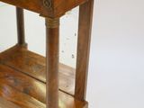 a small wooden table with a marble top on it