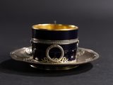 an image of a cup and saucer on a black table