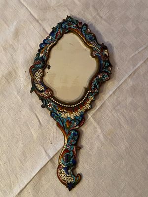 a mirror that is sitting on a table with a white table cloth