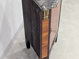 a small wooden cabinet with a marble top on wheels