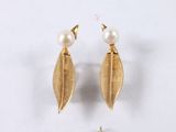 two pairs of gold earrings with pearls on them