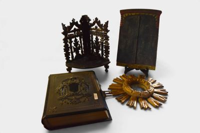 two books and a clock on a table next to a sunflower