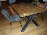 a wooden table with chairs around it on a hard wood floor