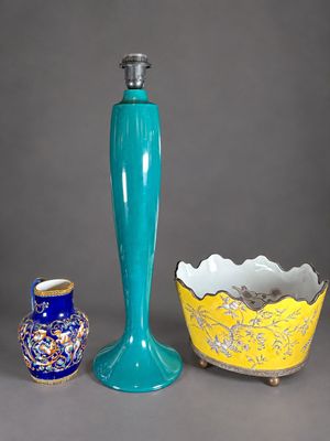 three vases and a candle holder on a table