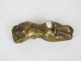 bronze sculpture of a hand holding a dog on a white surface