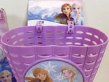 a purple basket with a picture on it next to other items