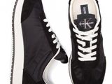 black sneakers with white laces and a logo on the sole