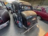 several old cars are parked in a garage next to each other