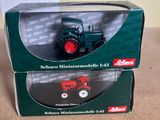 the box is open on the table with a toy tractor in it
