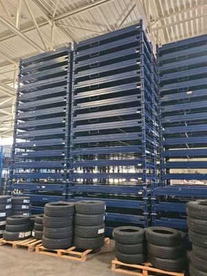 several stacks of tires are stacked on pallets in a warehouse