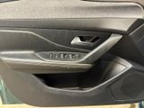 the inside of a car door with the door handle open