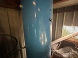 a large blue tank sitting in the middle of a room