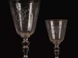 two empty wine glasses sitting on top of a wooden table