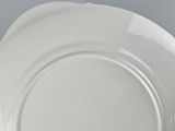 a white plate on a table with a blue background