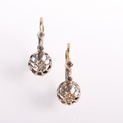 pair of gold and diamond earrings on a white background