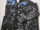 a pair of black and white jeans with a blue tag on them
