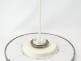 a white clock with a black bird on top of it