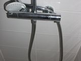 a shower head with a shower hose attached to it