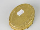 a gold coin sitting on top of a white table