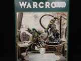 the box is full of warcro miniatures, including a green dragon and a white dragon