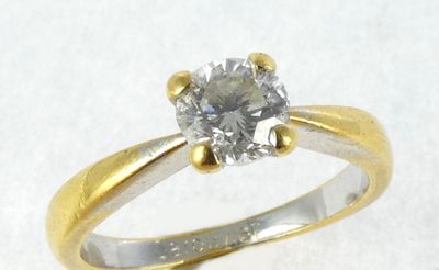 a ring with a diamond on it on a white surface