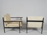 pair of lounge chairs in the style of person