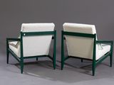 pair of green and white lounge chairs on a grey background