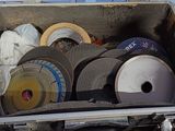 a metal box filled with different types of grinding wheels