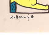 drawing of a yellow dog laying on a couch with a red heart in its mouth