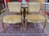 pair of upholstered chairs in a room with a rug on the floor
