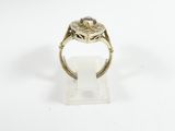 a close up of a gold ring with a stone in the center