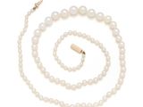 a white pearl necklace and bracelet set with a gold clasp