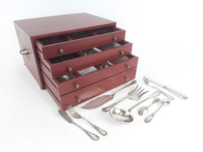 a red box with silverware in it on a white surface