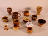 many different types of cups and saucers on the table