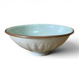 a white bowl with a brown rim on a white surface