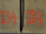 two patches with red numbers on them on a black surface
