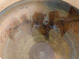 a close up of a plate with a leaf on it
