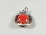 sterling silver pendant with a red stone in the middle of it
