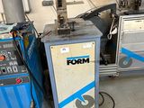 two machines that are sitting next to each other in a room