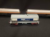 two toy trains that are sitting on a black surface