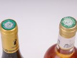 two bottles of wine sitting next to each other on a table